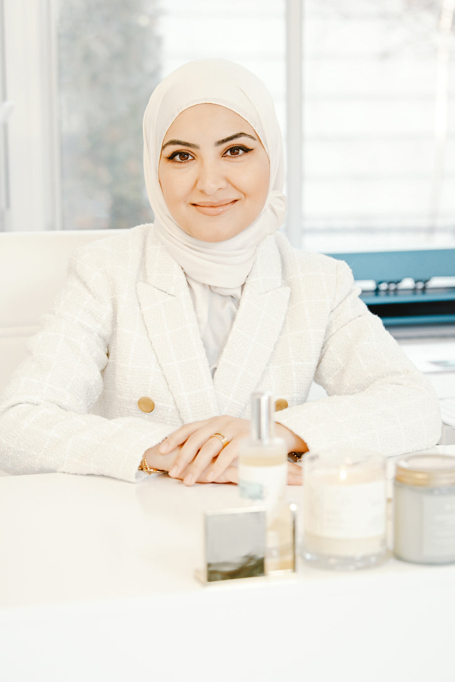 Farah Bazzi, artist and founder of Maraseel, seated at her desk in the studio