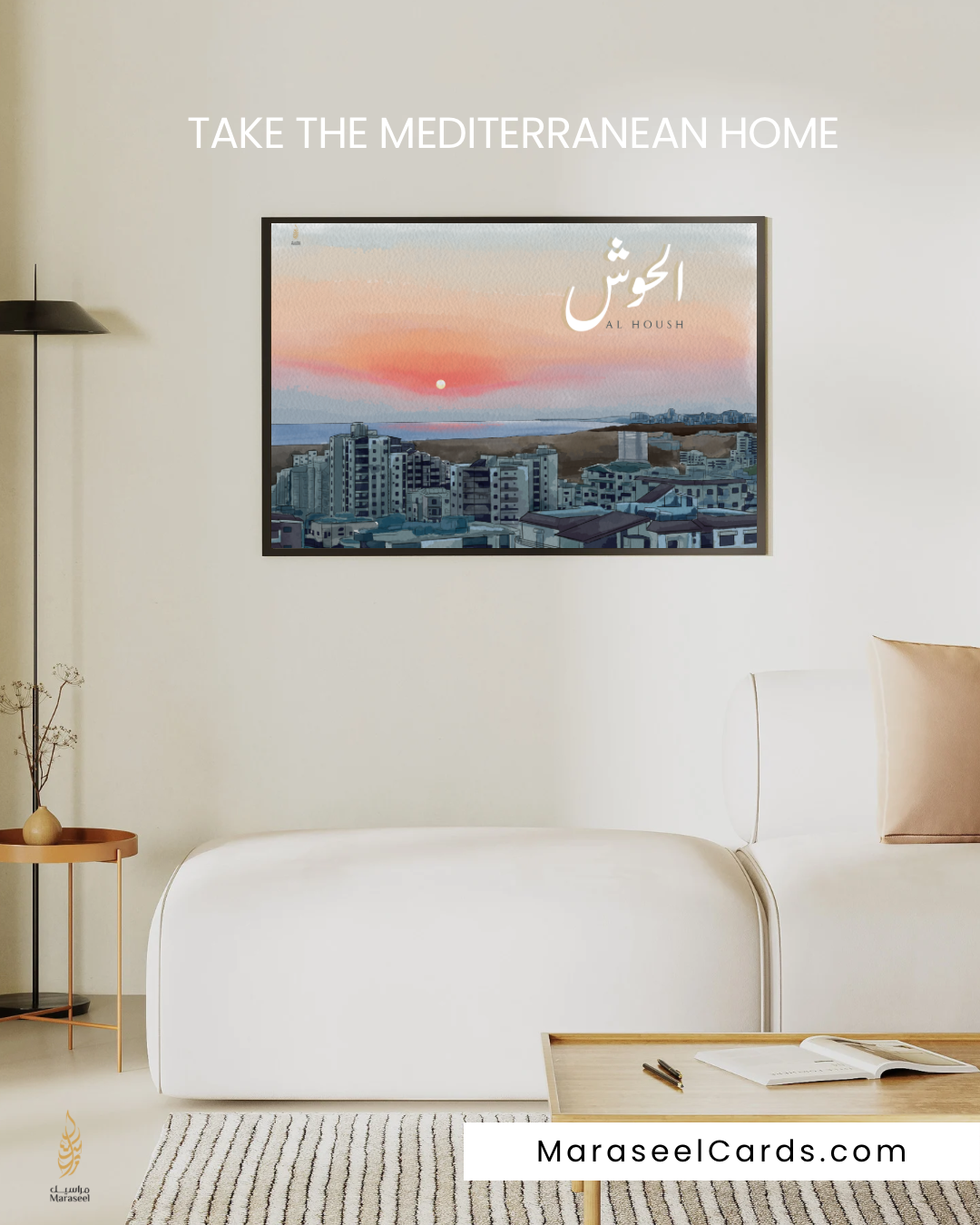 Living room with a framed picture of a cityscape on a white wall, featuring the text 'Take the Mediterranean Home' and 'MaraseelCards.com'.