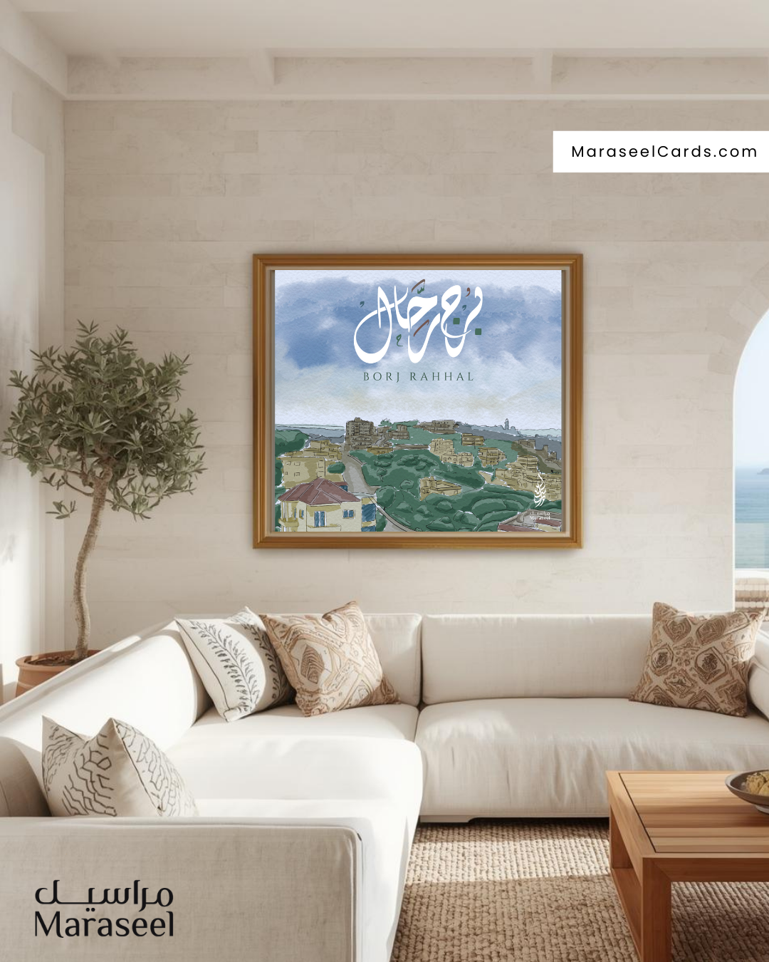 Framed Borj Rahhal art print hanging in a bright, Mediterranean-style villa living room with neutral tones, textured pillows, and a coastal view through the window.