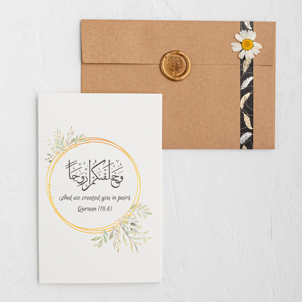 Card with floral design and envelope on a light gray background