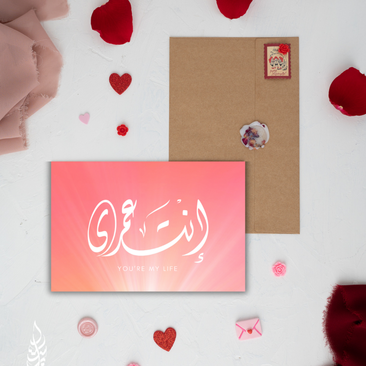Two greeting cards on a white surface with red heart decorations and a pink gradient card.