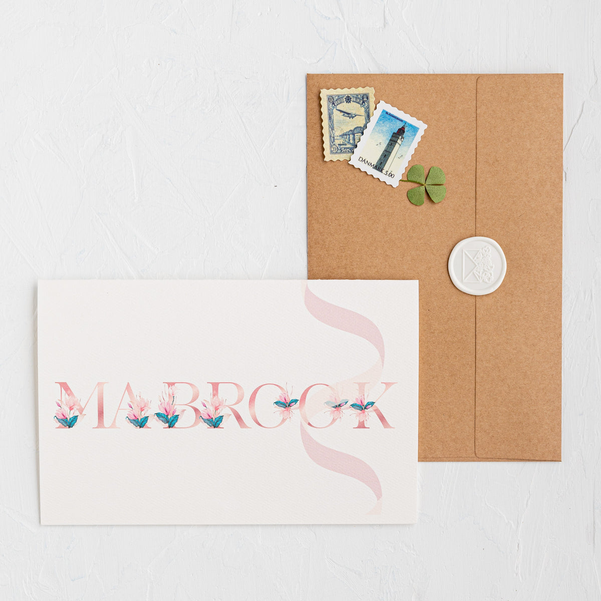 Card with 'Marbrook' design and a brown envelope on a white background