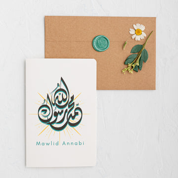 Card with Arabic text 'Mawlid Annabi' featuring a flower and envelope on a white background