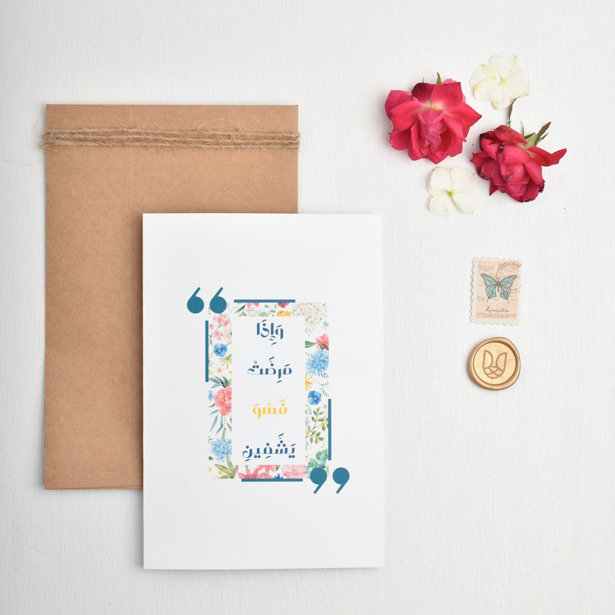 Floral card with envelopes and decorative items on a white background