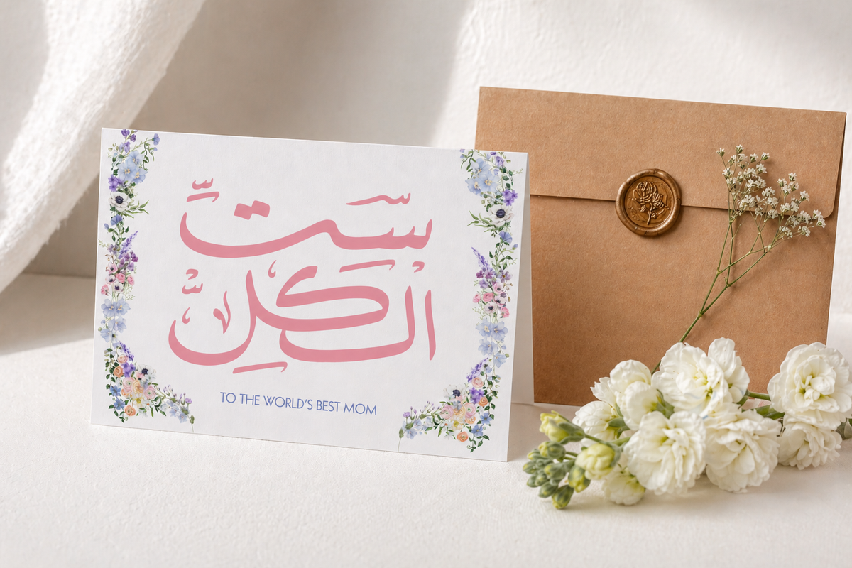 Greeting card with Arabic text and flowers on a white surface