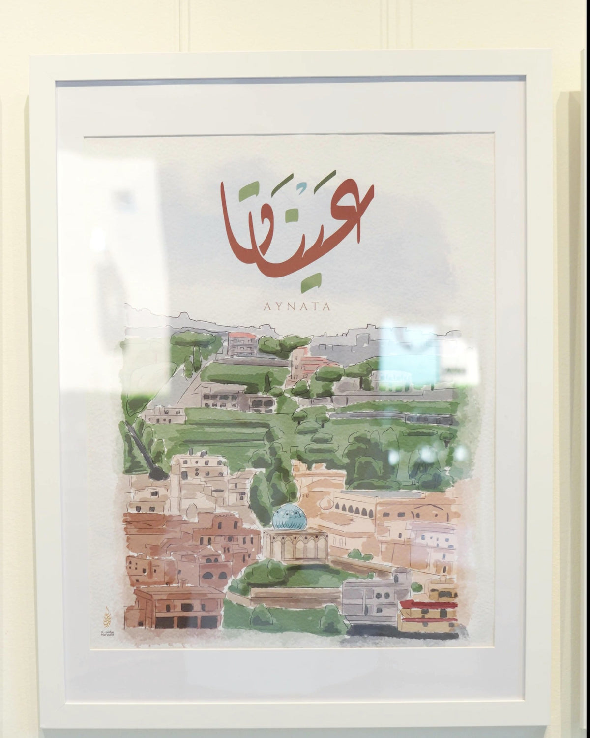 Aynata (عيناتا), South Lebanon print: the village's houses and green terraces in watercolour, framed at Motherland, Maraseel's print exhibition at Black Box Coffee in Dearborn, May 2026