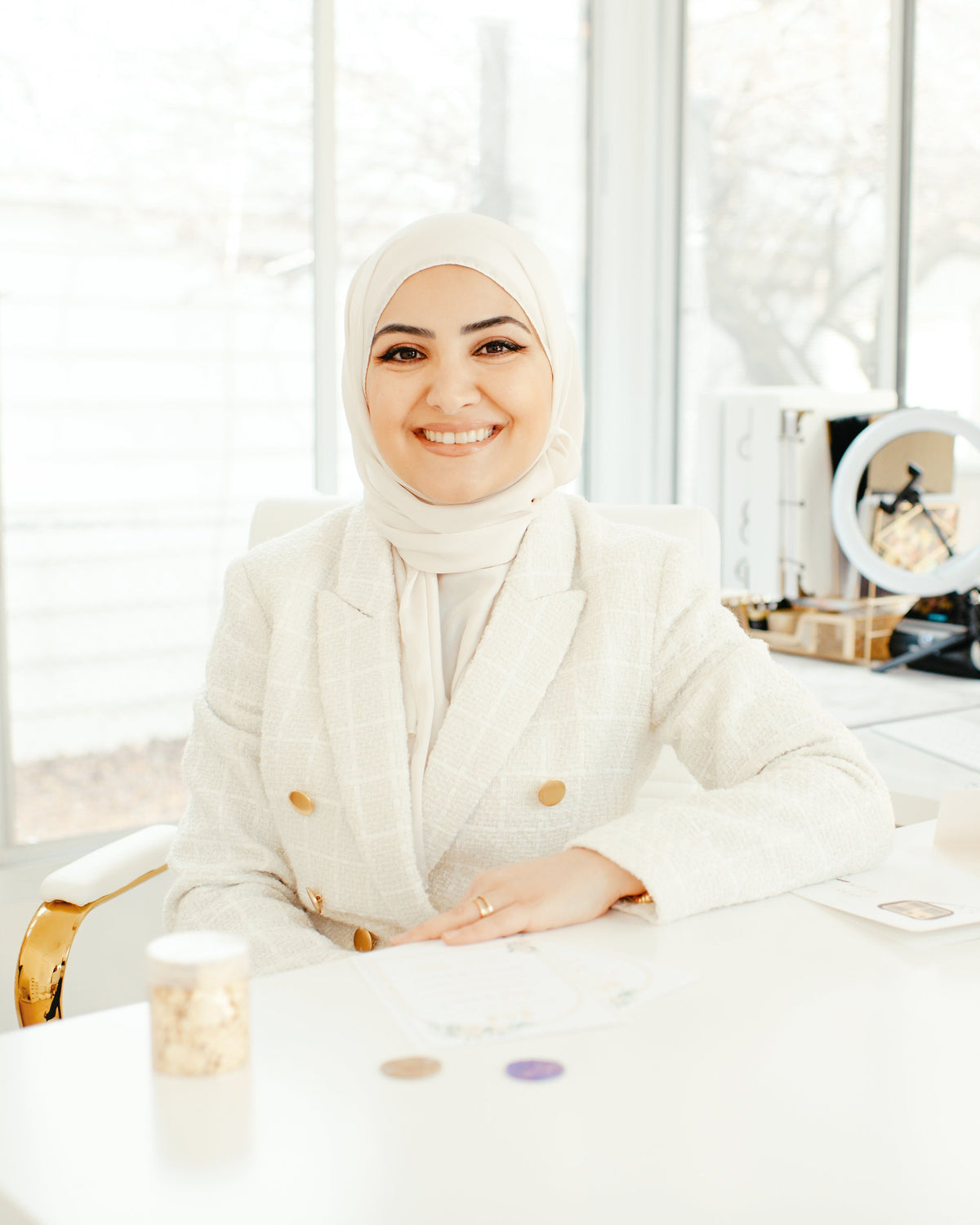 Farah Bazzi, founder of Maraseel, smiling at her desk in the Maraseel studio